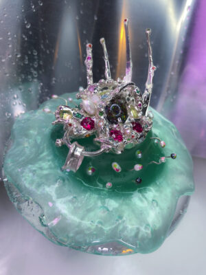 DK - Alien Baby + Pod - 2019 - Silver with a range of semi-precious gemstones, pearl, and matrix opal centre, Acrylic and slime pod - Image by DK
